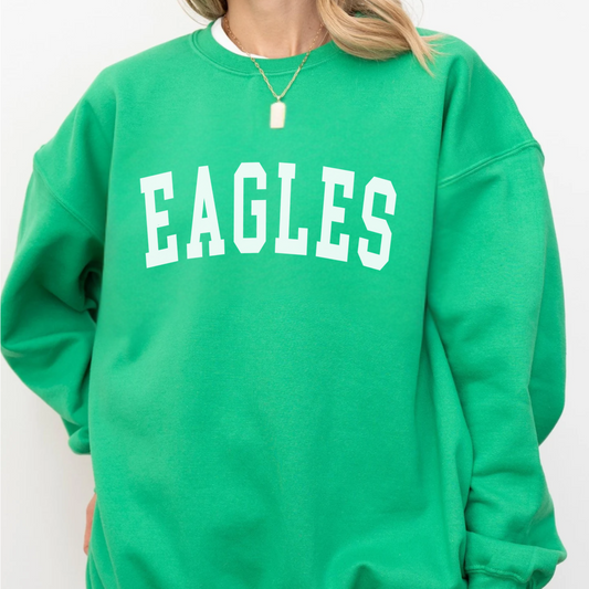 Green sweatshirt with 'EAGLES' text worn by a person on a white background
